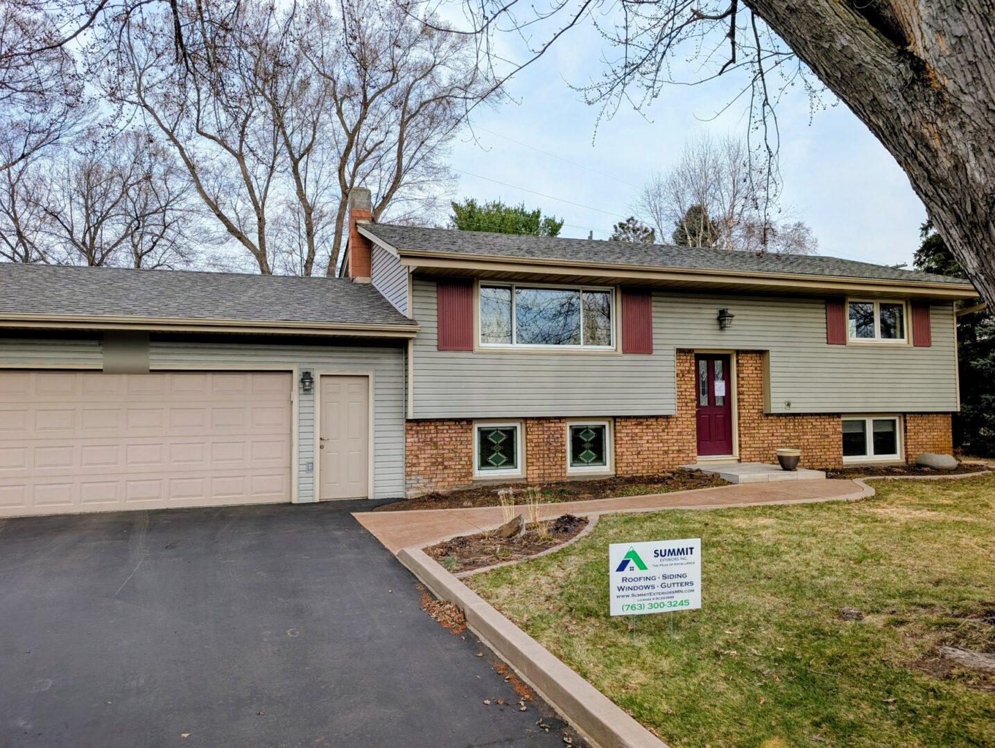 Completed asphalt shingle roof replacement on the front of a 114th Court North home in Champlin Minnesota