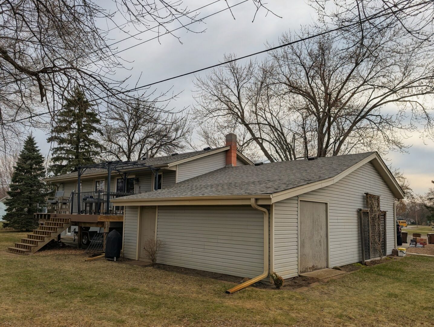 Completed asphalt shingle roof replacement on the rear and garage of a 114th Court North home in Champlin Minnesota