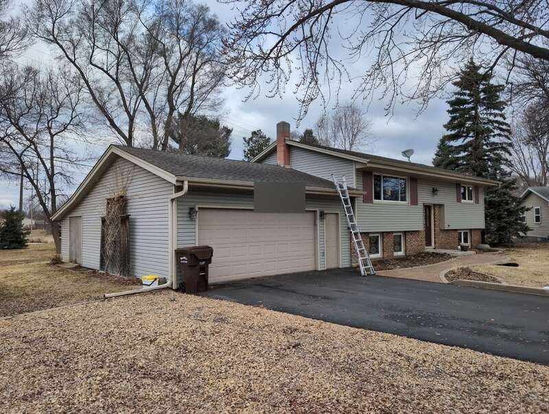 Front view of a Champlin home before roof replacement on 114th Court North