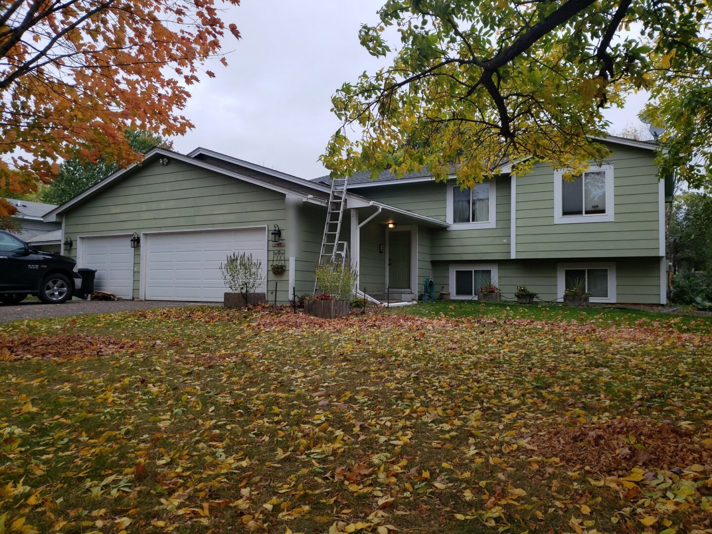 Champlin home before GAF HDZ roof and Alside Charter Oak vinyl siding installation on 116th Avenue North