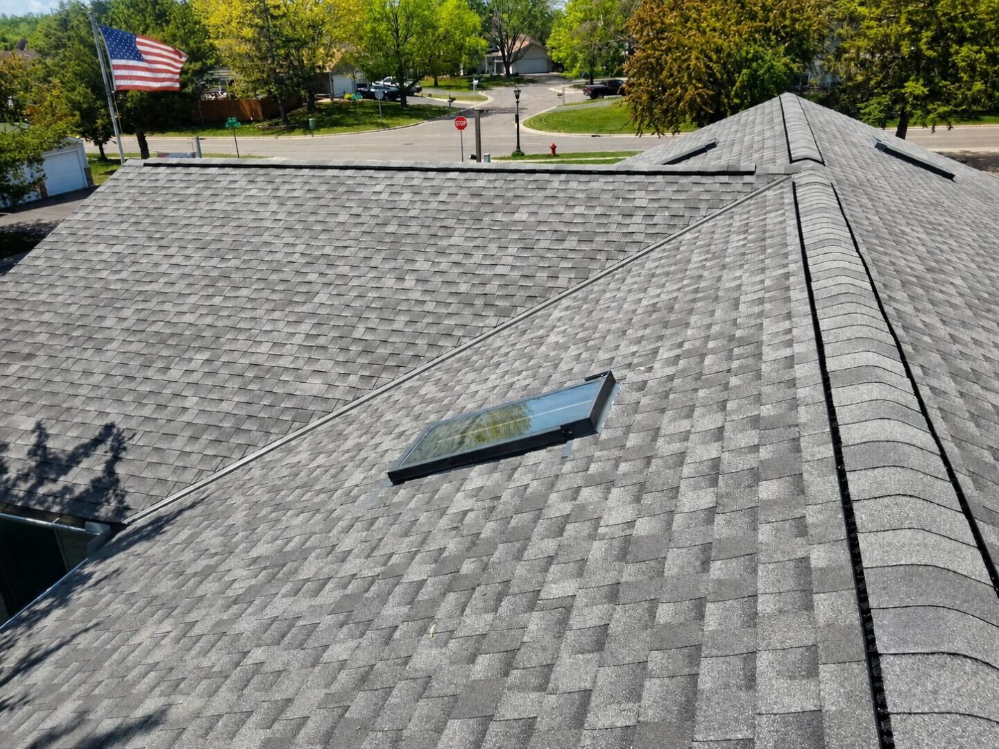 Completed GAF Timberline HDZ roof with skylight and multiple roof planes on Gettysburg Avenue North in Champlin, Minnesota