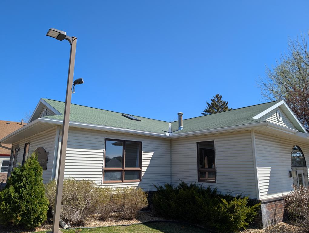 Front view of community center roof before replacement on Gettysburg Avenue North in Champlin, Minnesota