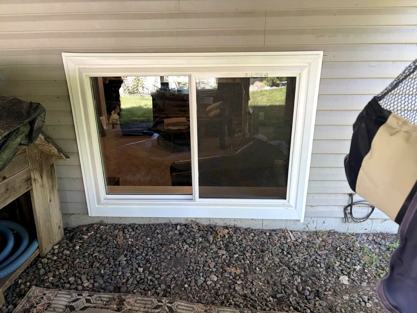 Exterior view of a new Alside Mezzo vinyl sliding window and white trim on Kalland Avenue NE in Albertville, Minnesota