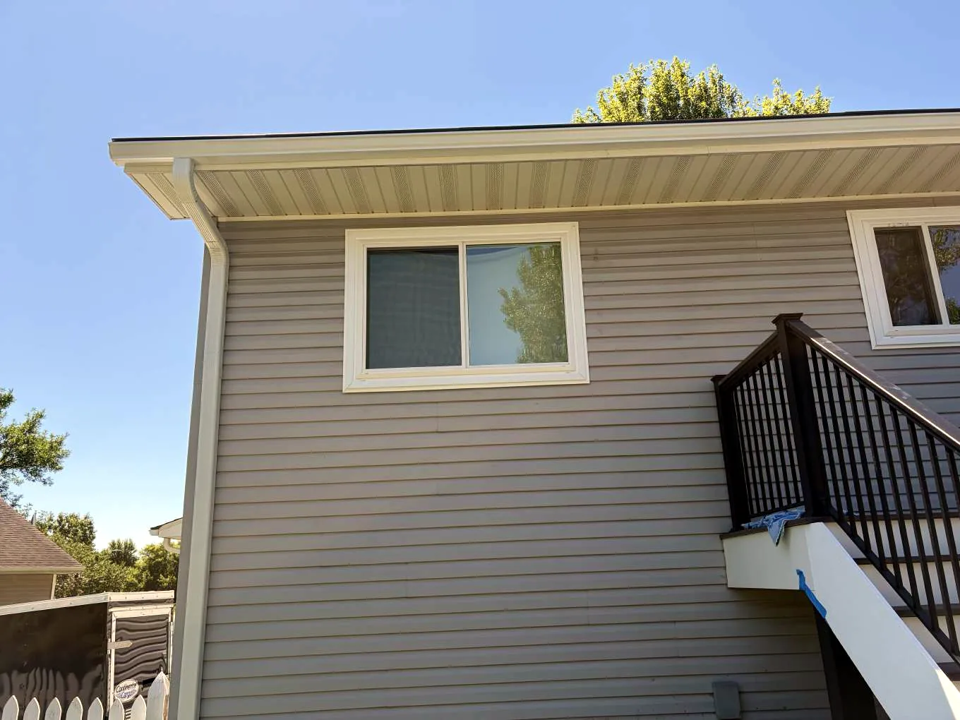 Completed Alside Mezzo vinyl window installation on the rear elevation of a Kalland Avenue NE home in Albertville, Minnesota