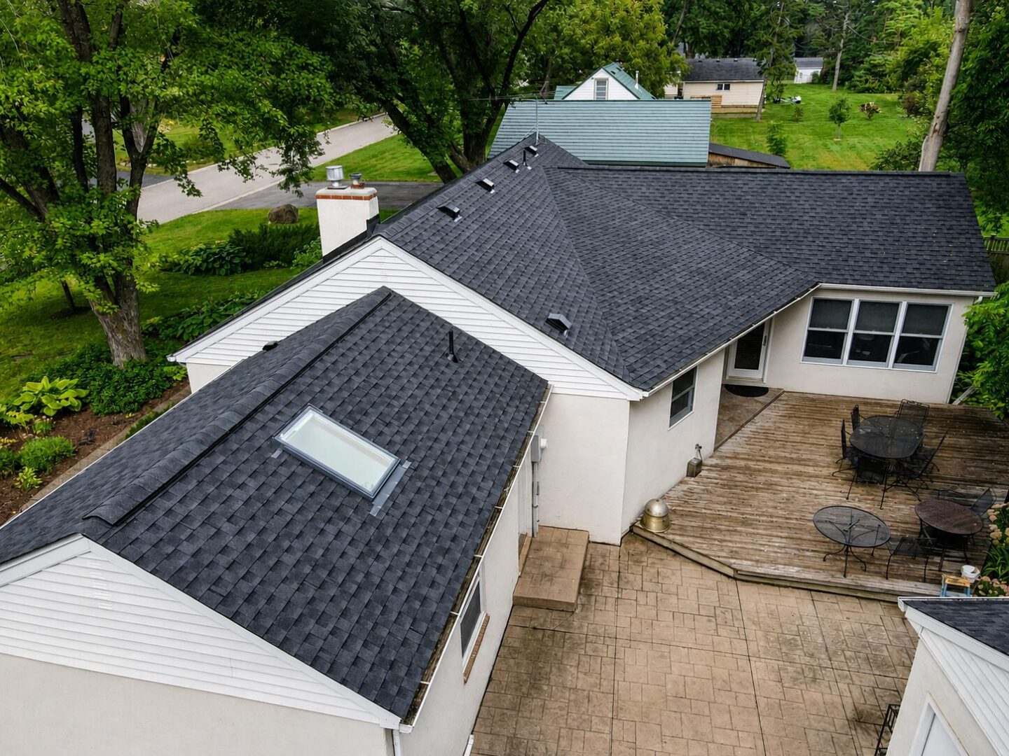 Completed GAF Timberline HDZ roof with skylight, vents and chimney flashing on Leroy Street in Wayzata, Minnesota