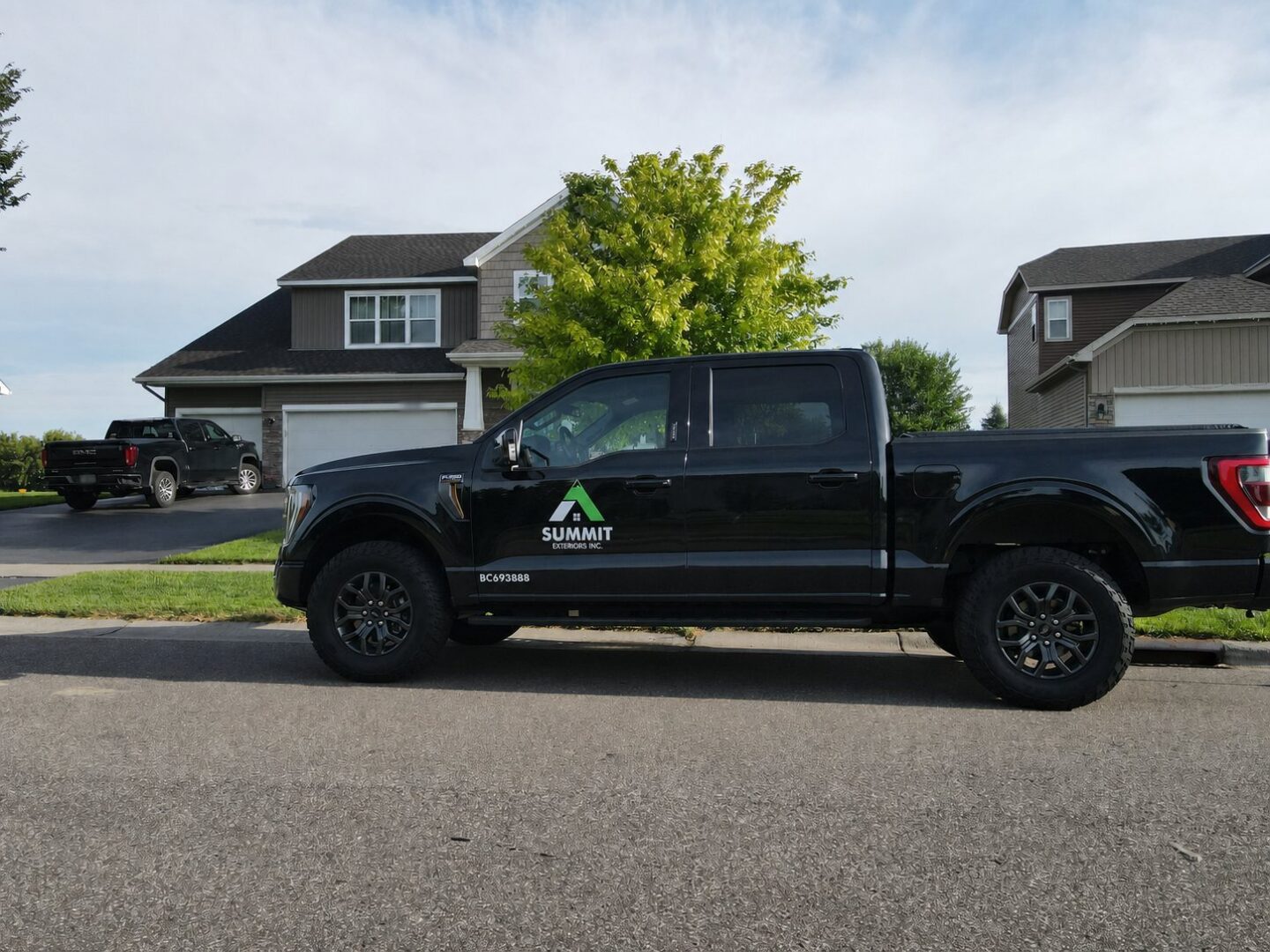 Summit Exteriors truck in front of a completed GAF Timberline HDZ roof replacement on 68th Circle NE in Otsego, Minnesota